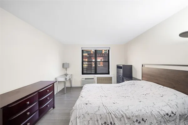 a bedroom with a bed and a desk