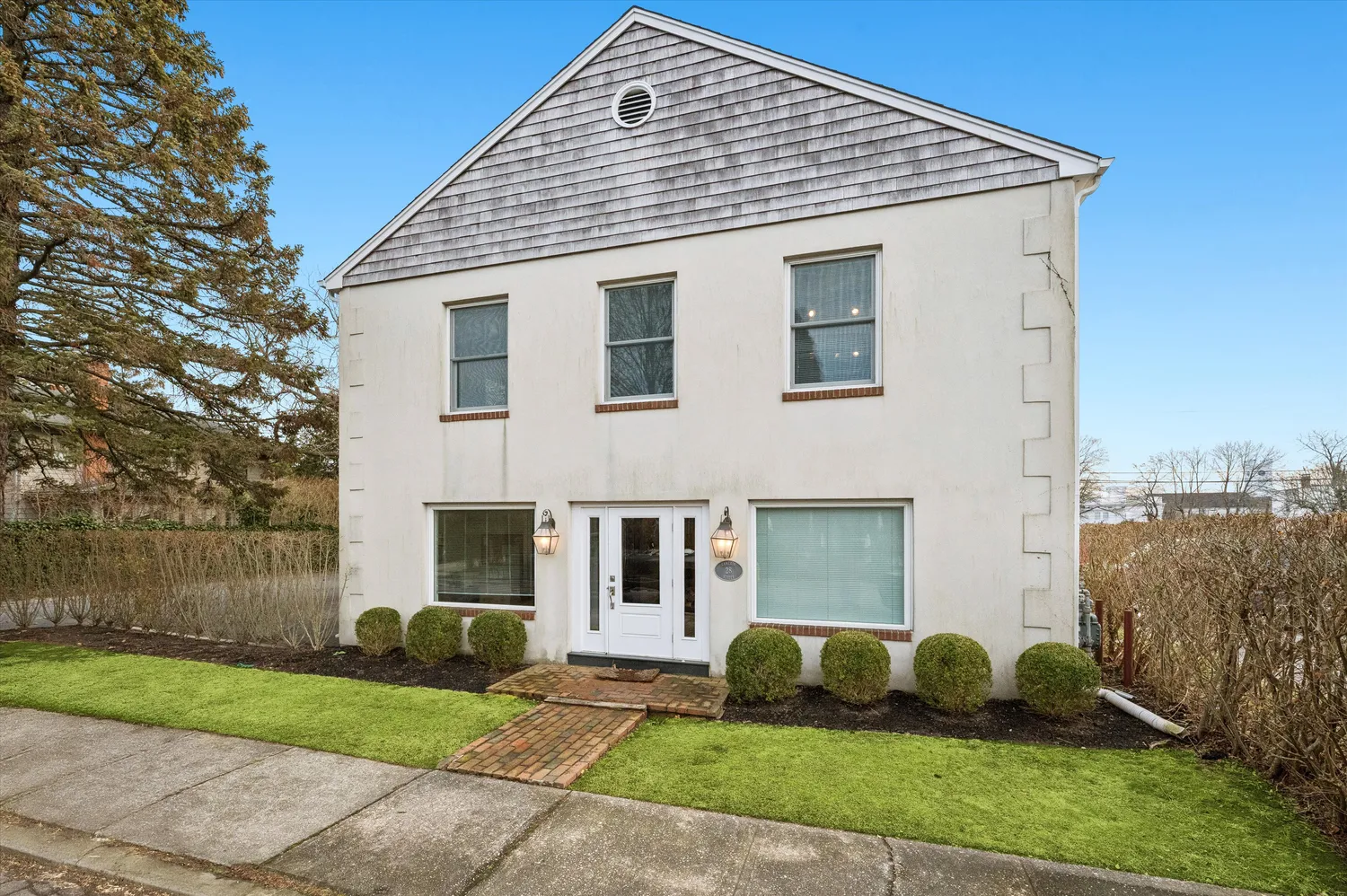 a front view of a house with a garden