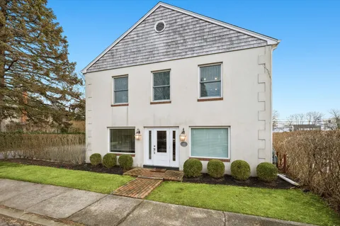 a front view of a house with a garden
