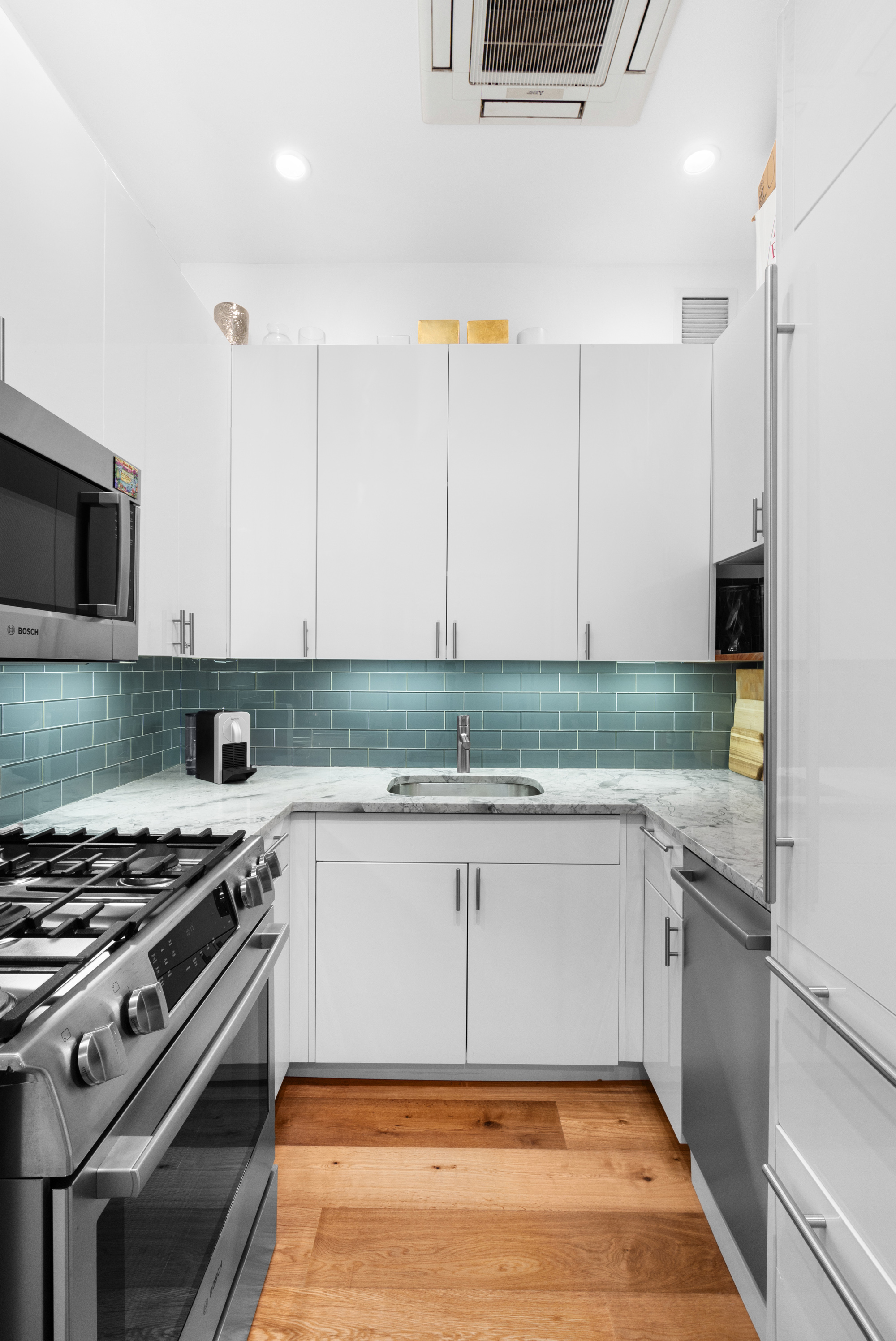 425 Park Avenue South, Unit 20D Manhattan, NY 10016 - Photo 3 of 7 a kitchen with stainless steel appliances a stove a sink and a refrigerator