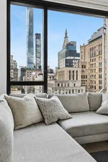 a living room with couches and a large window