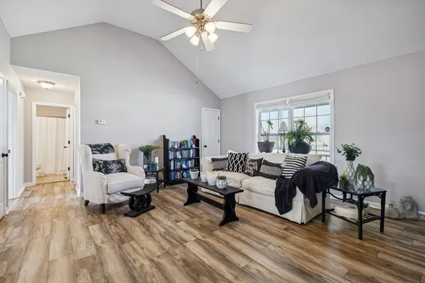 a living room with furniture and a wooden floor