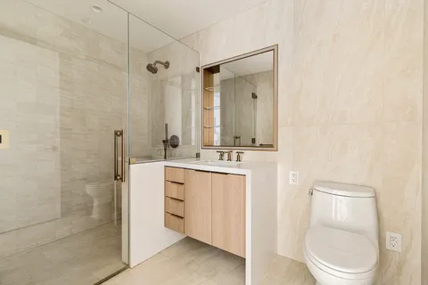 a bathroom with a toilet a sink and a shower