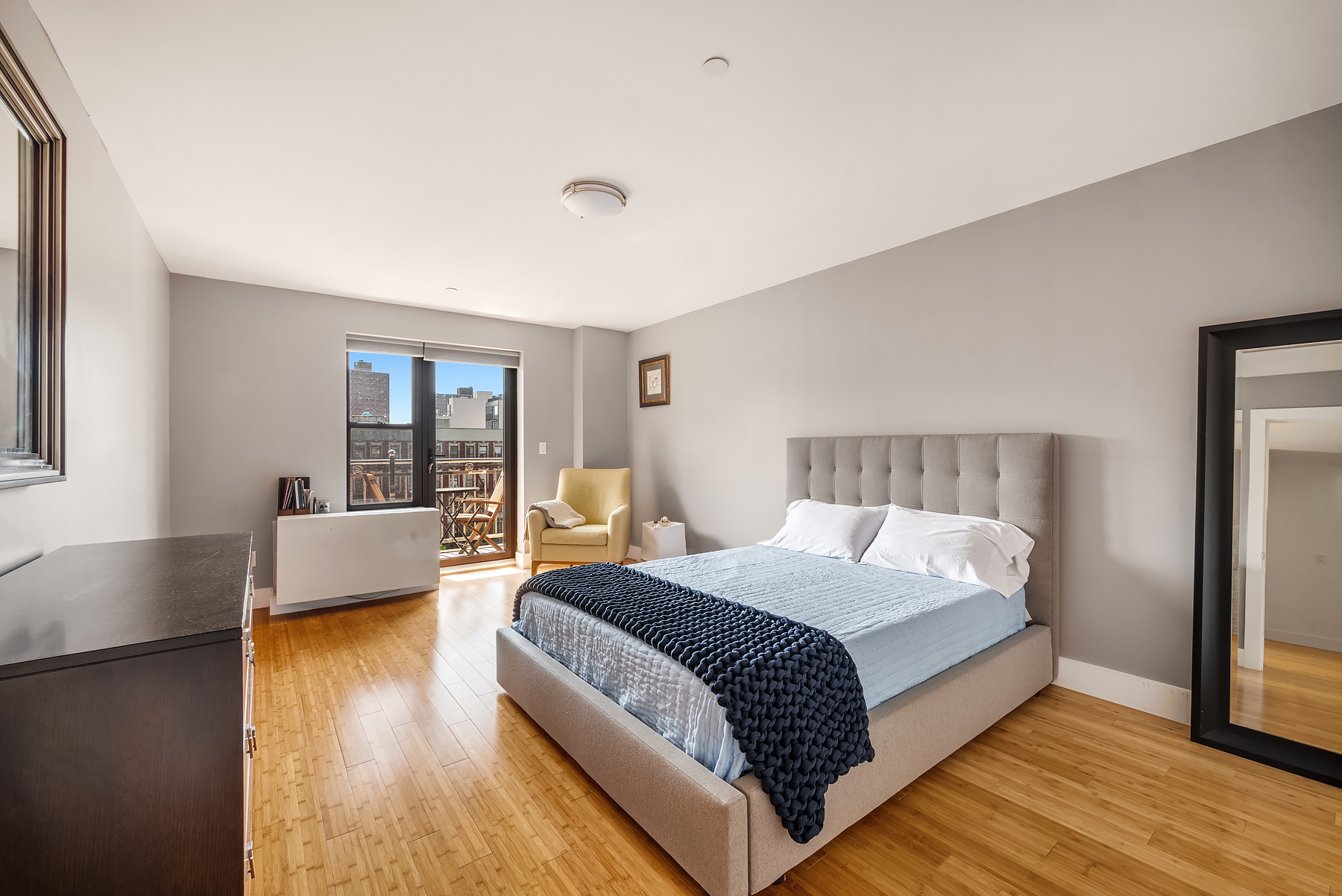 234 West 148th Street, Unit 5C Manhattan, NY 10039 - Photo 4 of 15 a bedroom with a bed and a couch