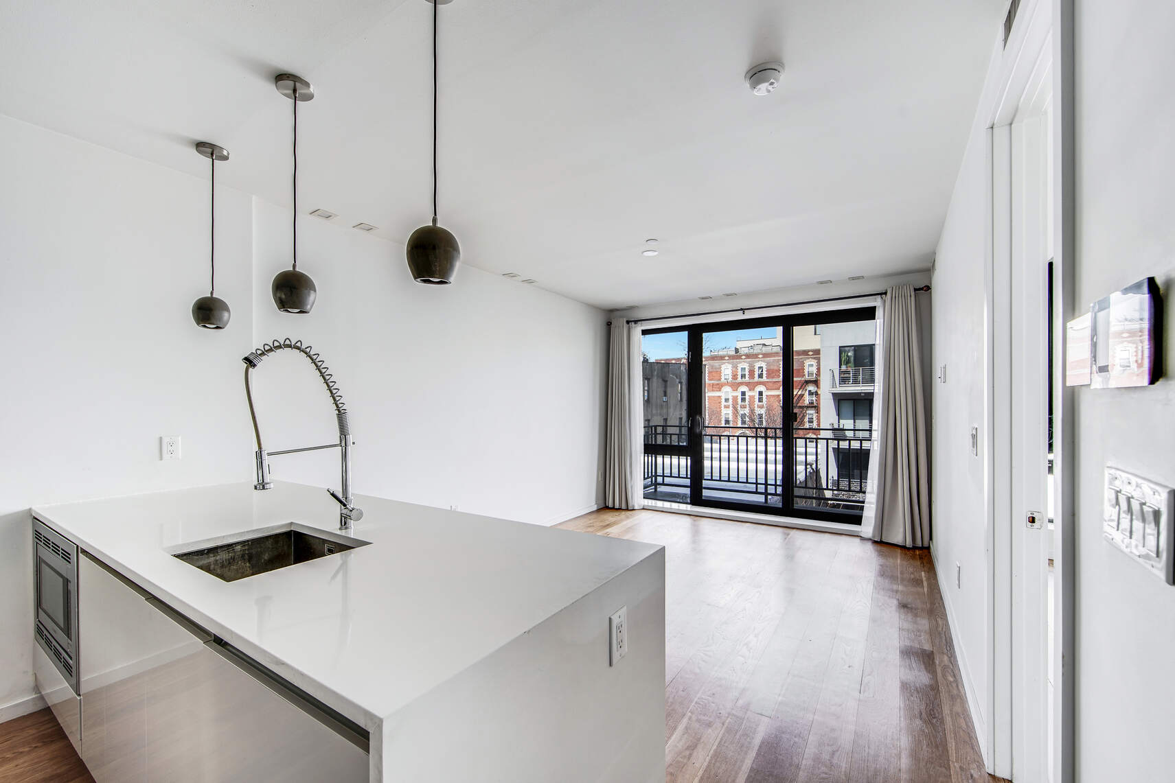 511 Lafayette Avenue, Unit 3B Brooklyn, NY 11205 - Photo 6 of 14 a kitchen with kitchen island a stove a sink and wooden floor