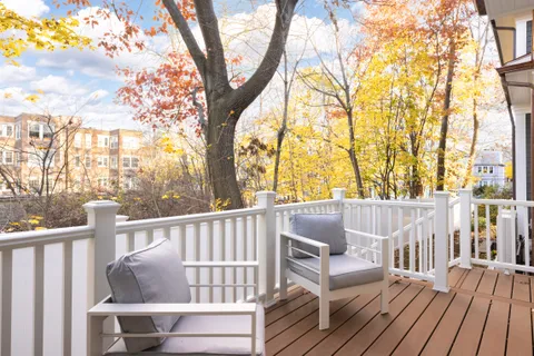 a view of deck with couches and wooden fence