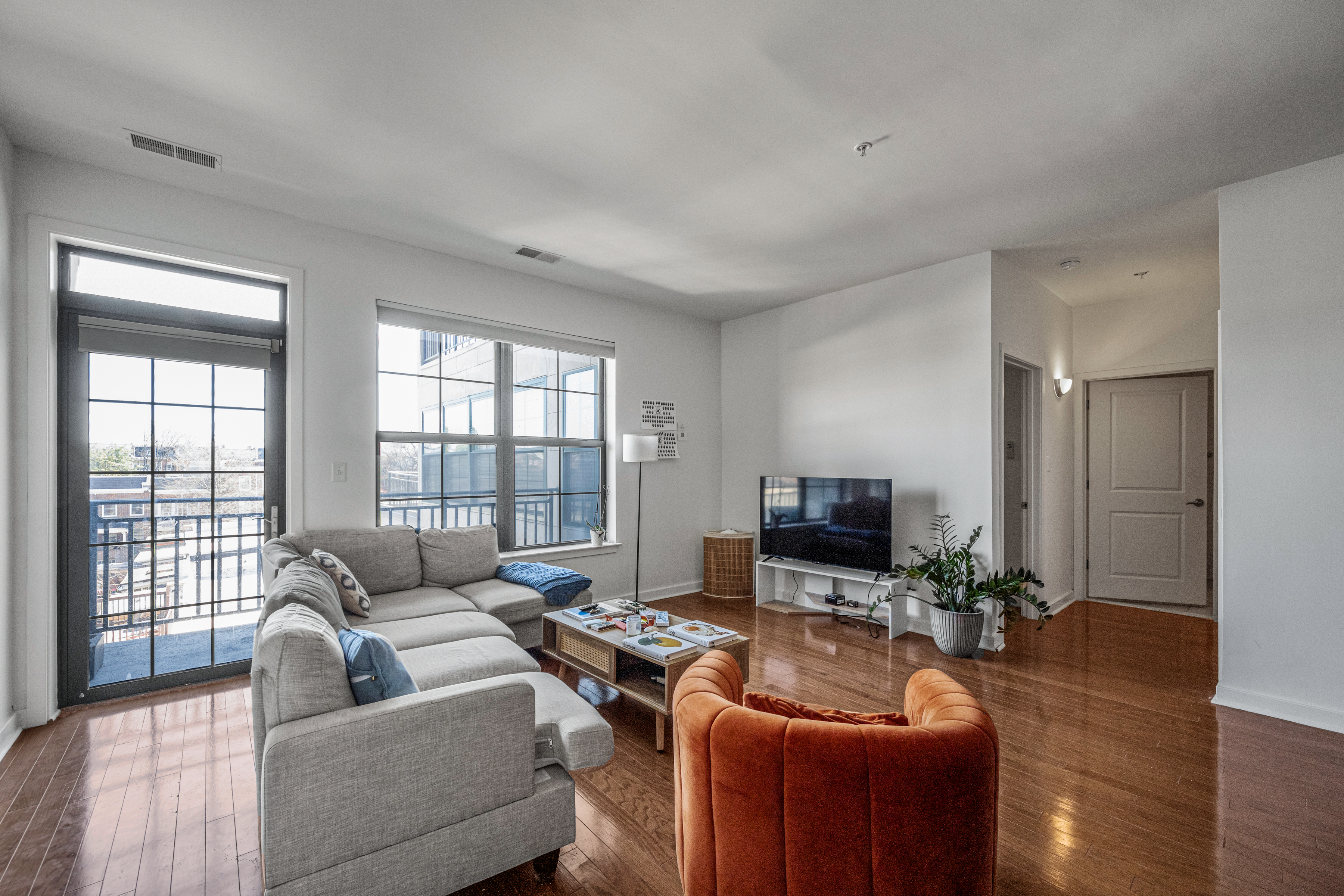 3201 St Paul Street, Unit 310 Baltimore, MD 21218 - Photo 10 of 20 a living room with furniture and a flat screen tv