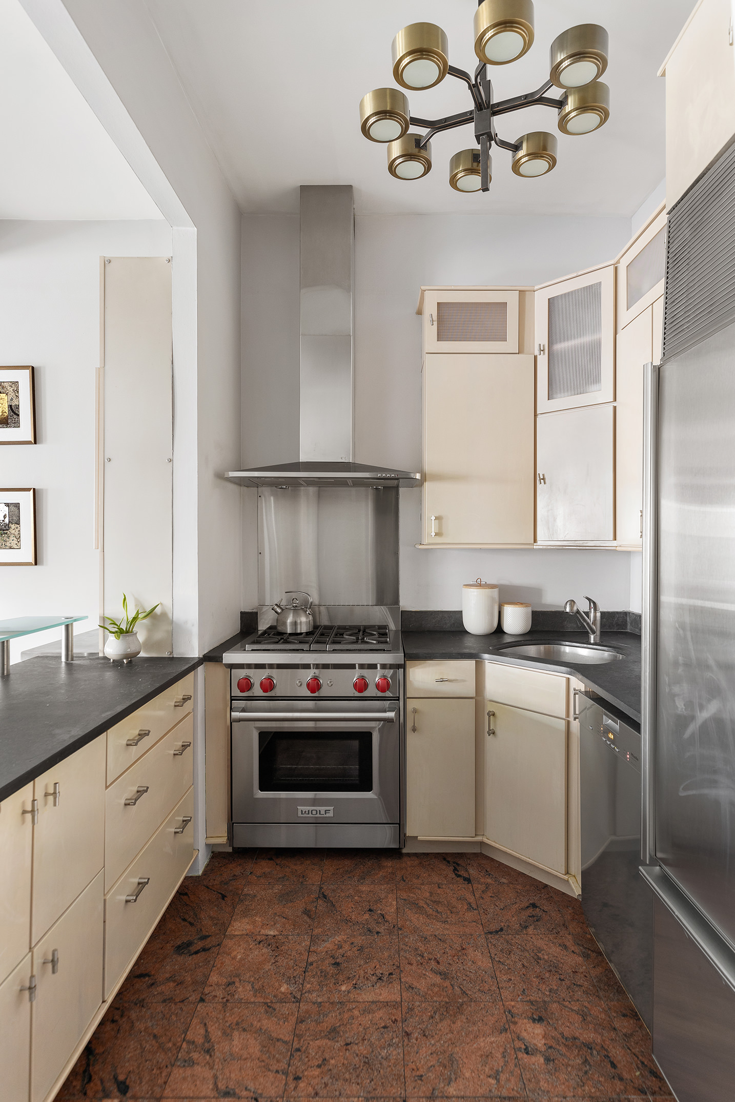 204 West Houston Street, Unit 4B Manhattan, NY 10014 - Photo 4 of 10 a kitchen with a stove sink and cabinets
