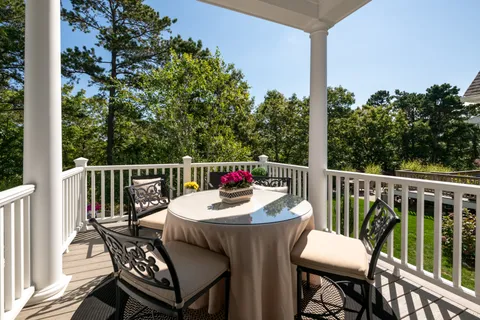 a balcony with wooden floor and fence