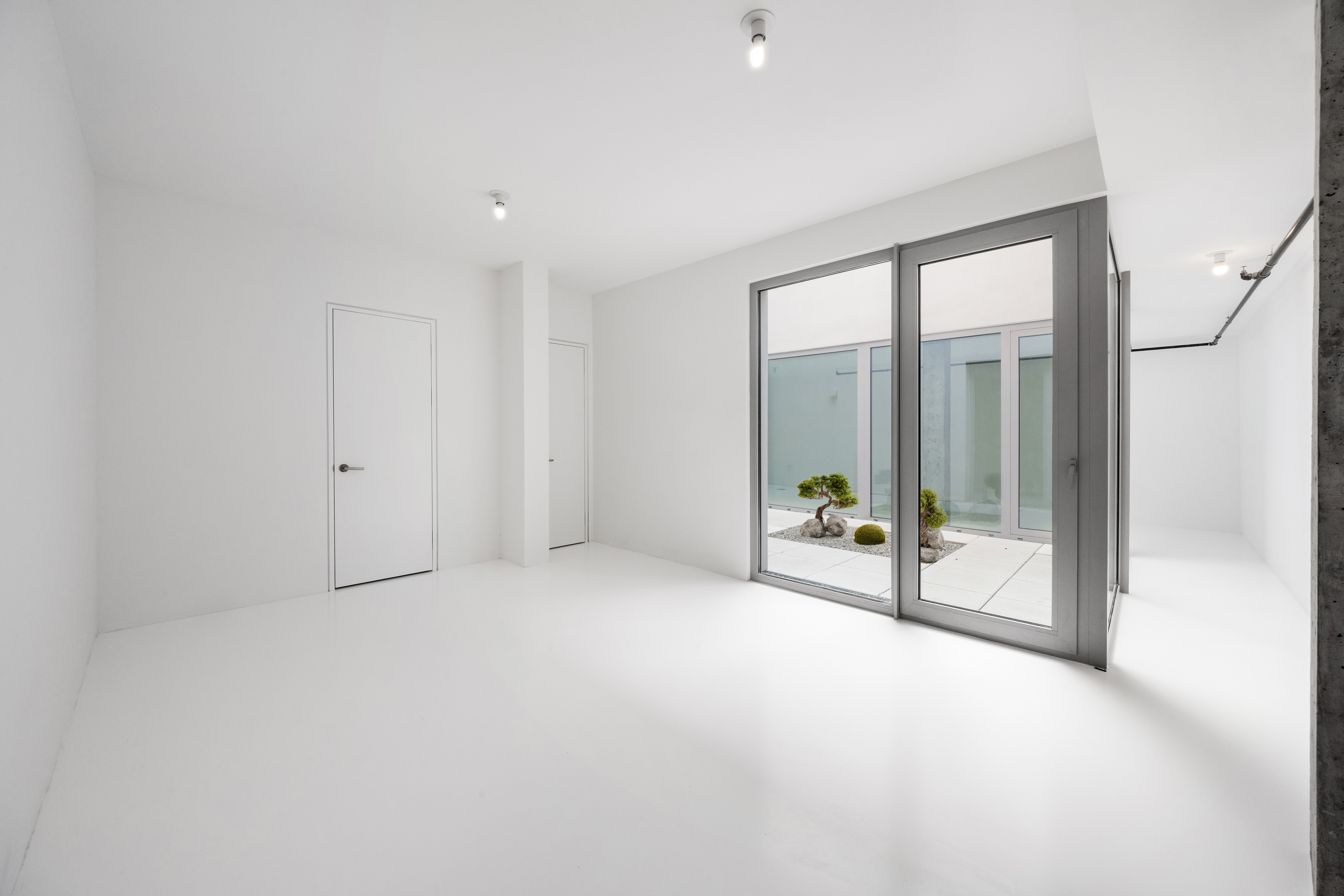 272 Greene Avenue Brooklyn, NY 11238 - Photo 15 of 19 an empty room with sliding glass door and shower