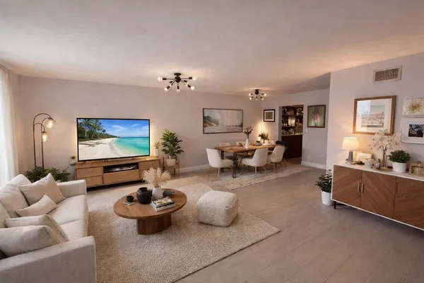 a living room with furniture and wooden floor