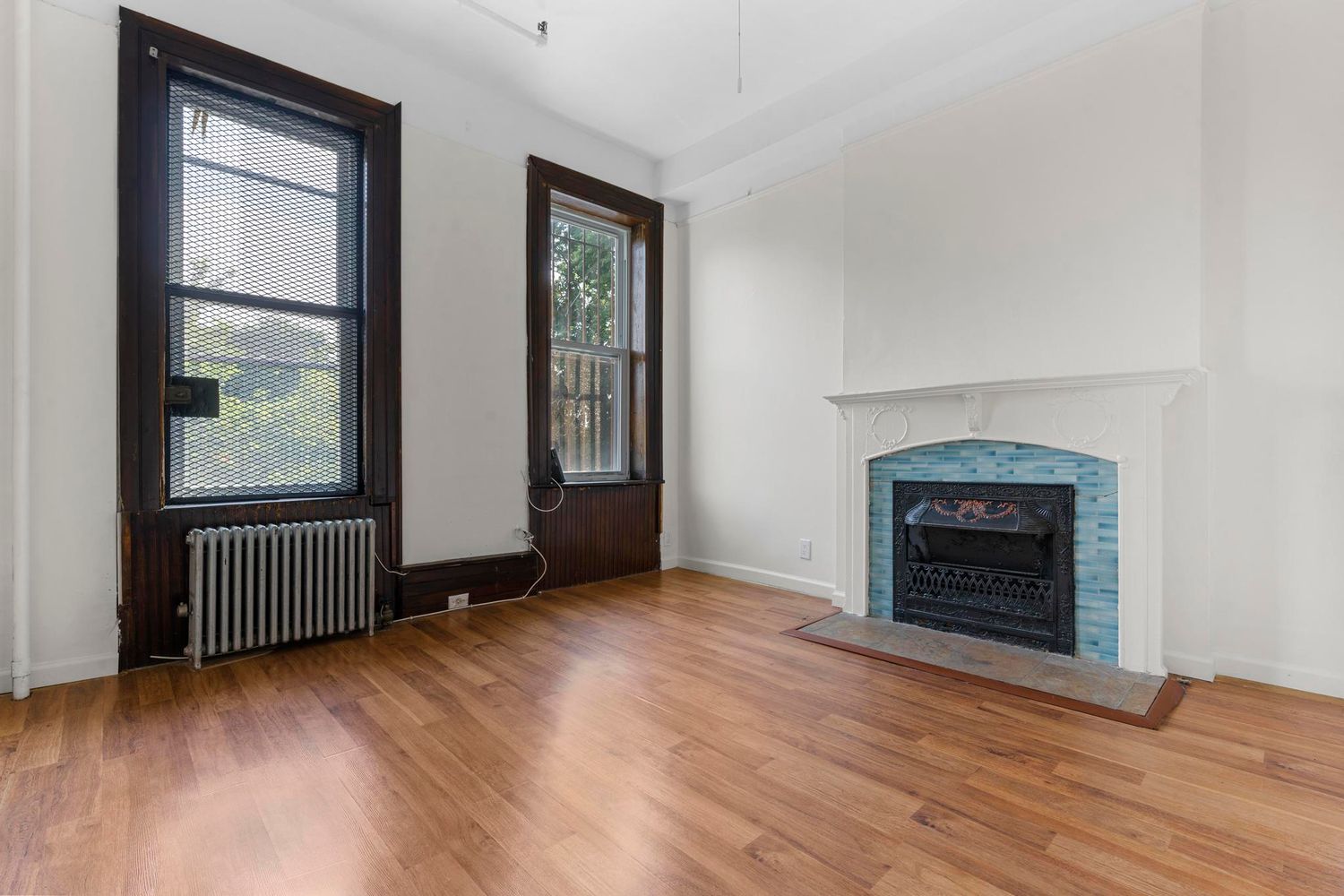 880 Park Place, Unit 2 Brooklyn, NY 11216 - Photo 9 of 12 an empty room with wooden floor fireplace and windows