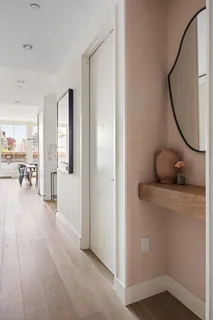 a view of a room with wooden floor and furniture