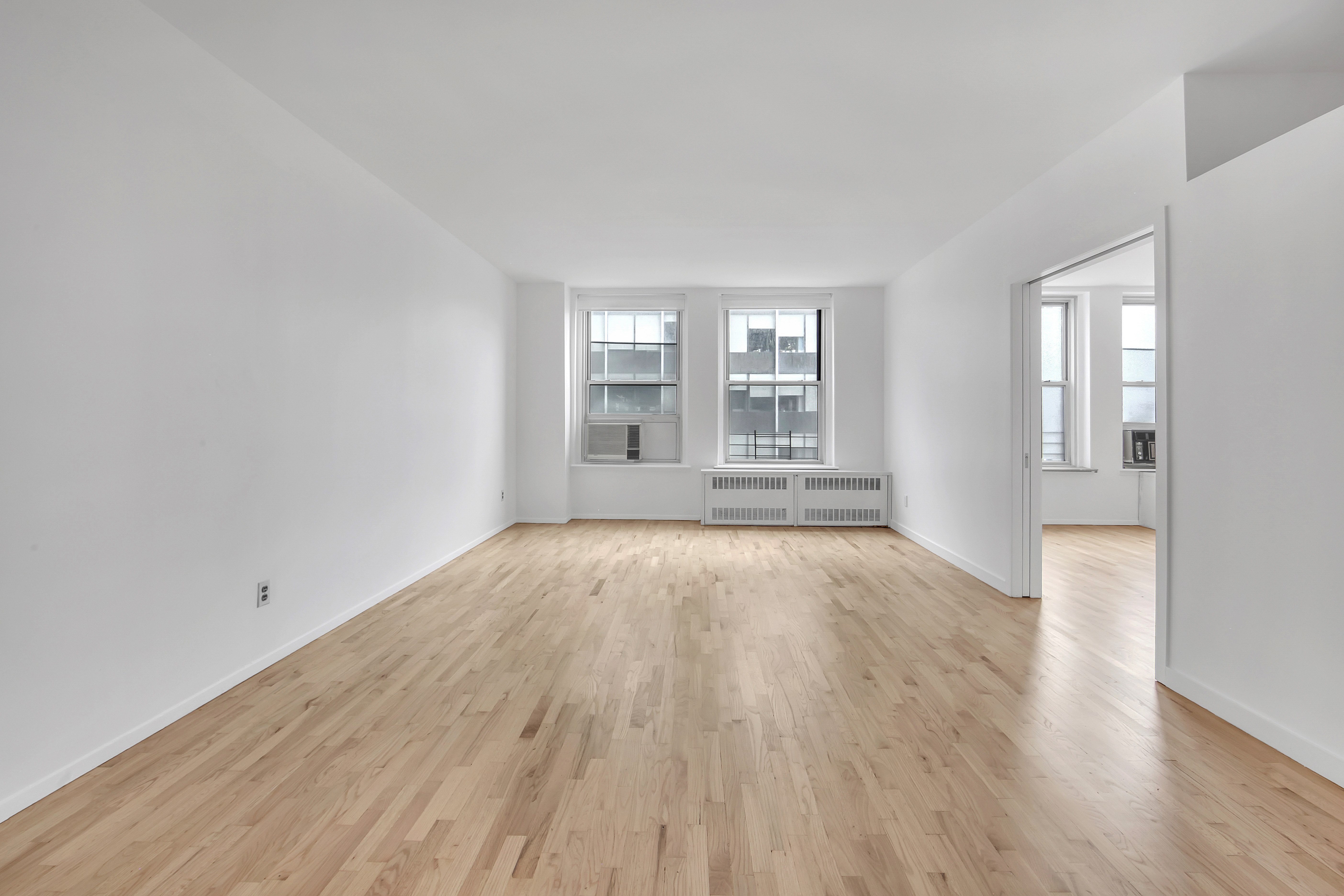 75 Livingston Street, Unit 9B Brooklyn, NY 11201 - Photo 7 of 13 an empty room with wooden floor and windows