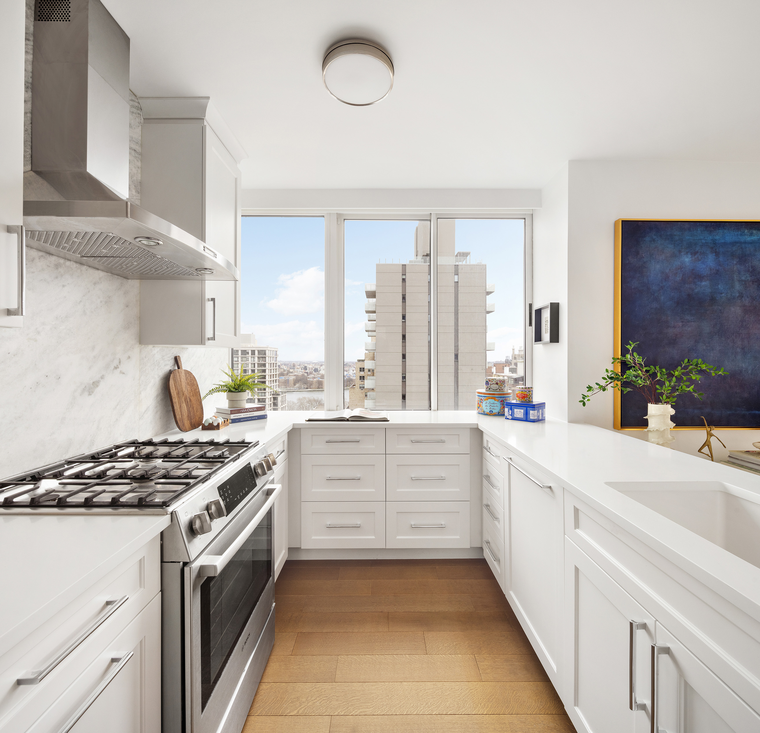 455 East 86th Street, Unit 20E Manhattan, NY 10028 - Photo 4 of 14 a kitchen with white cabinets and appliances