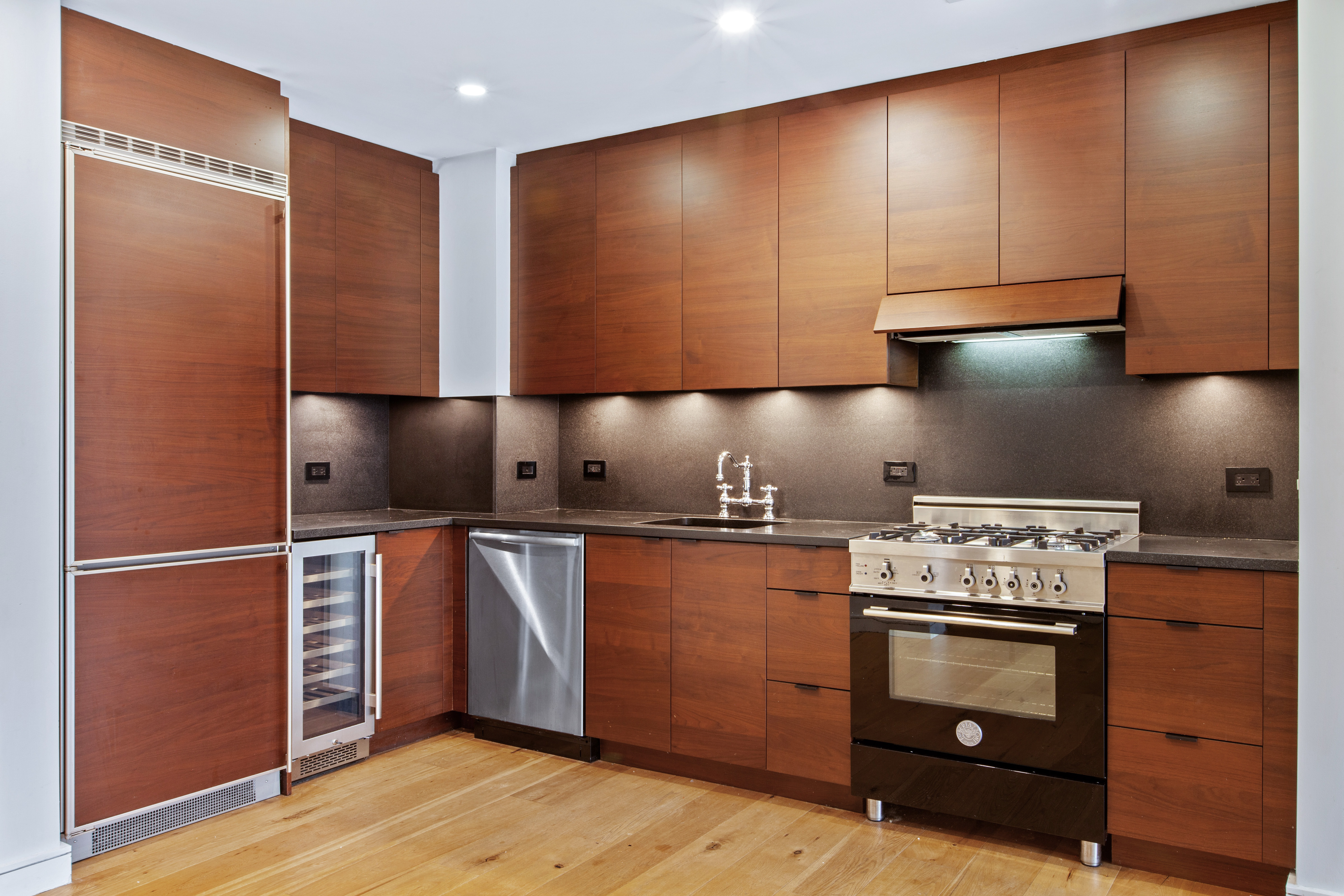 540 West 28th Street, Unit 4F Manhattan, NY 10001 - Photo 4 of 16 a kitchen with stainless steel appliances granite countertop a stove a sink and a refrigerator