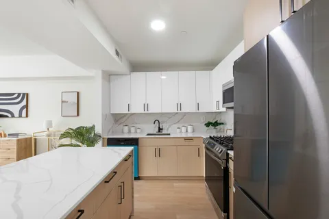 a kitchen with a sink and cabinets