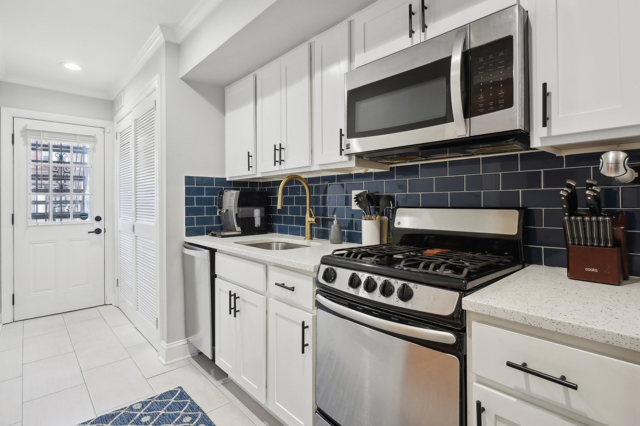 123 17th Street Southeast Washington, DC 20003 - Photo 8 of 18 a kitchen with stainless steel appliances a stove a microwave and cabinets