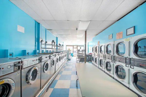 a utility room with multiple dryer and washer
