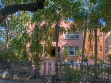 a view of a large building with a tree