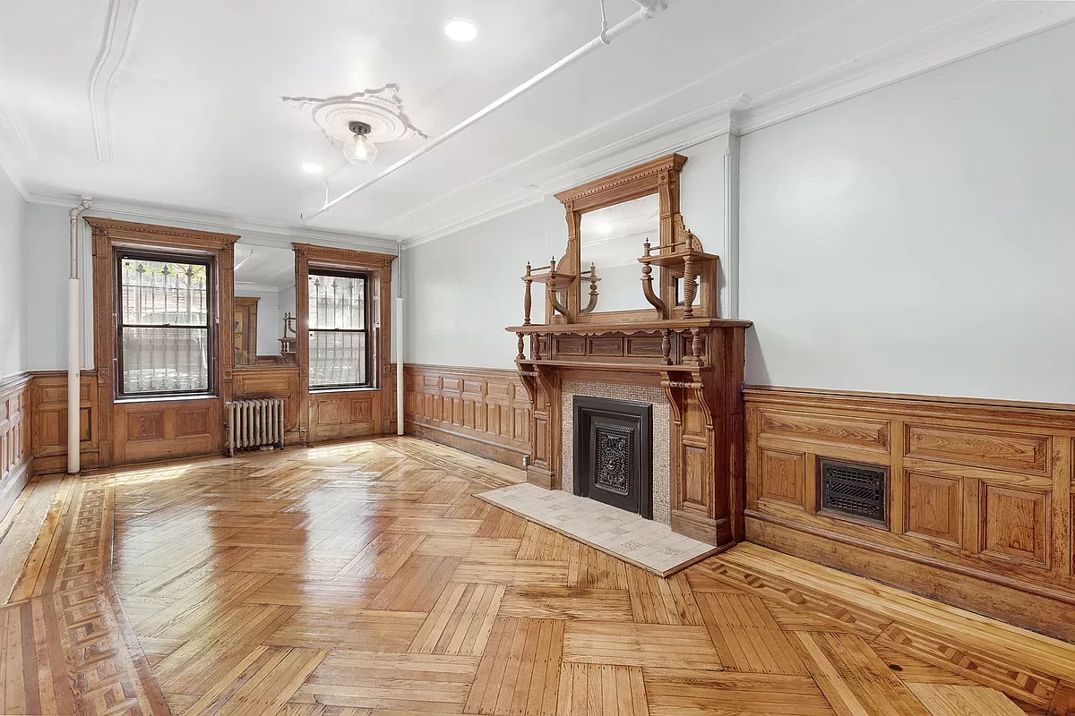 a view of empty room with wooden floor and fireplace