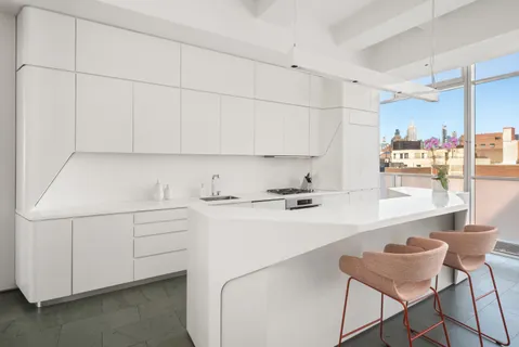 a kitchen with a sink cabinets and wooden floor