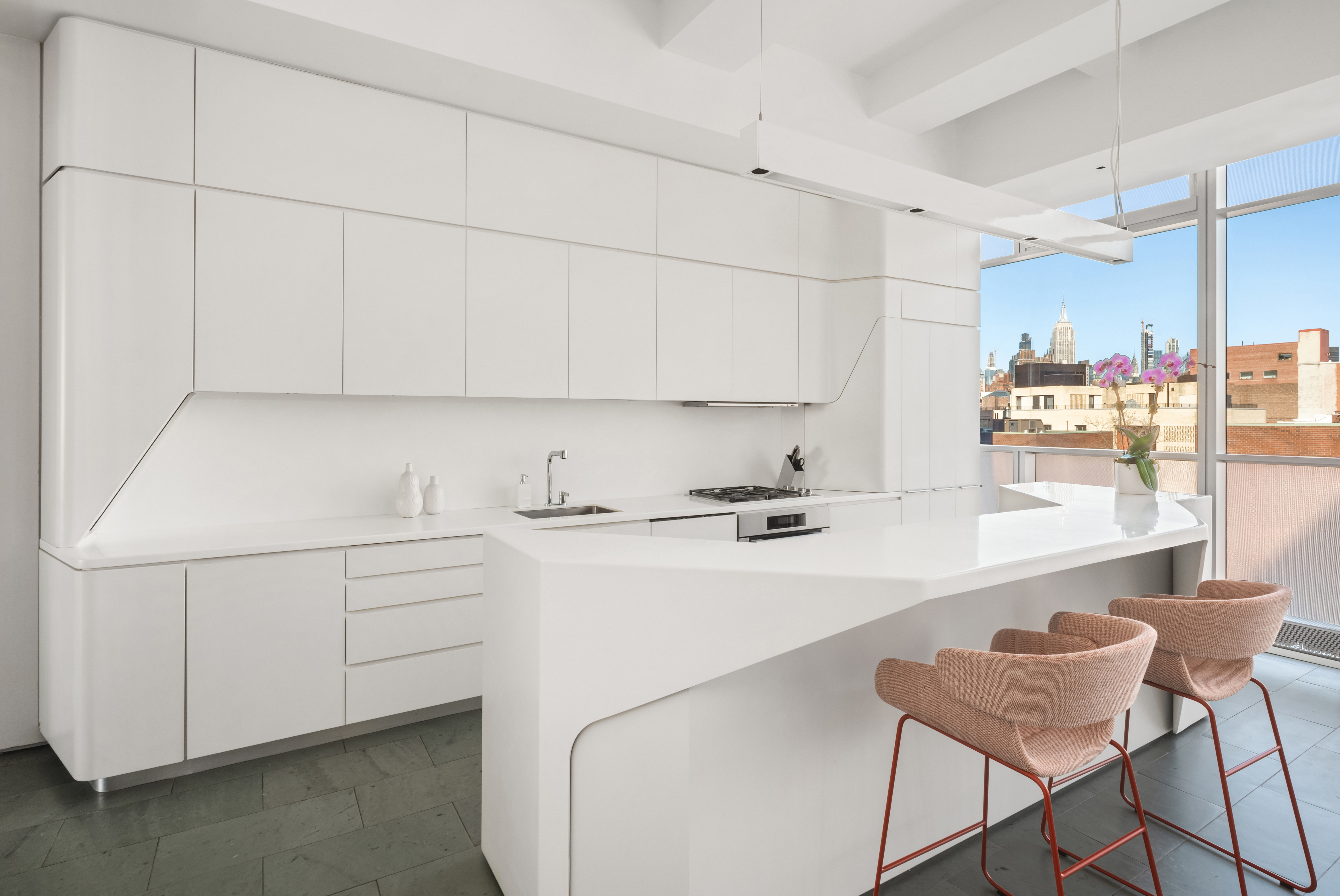 166 Perry Street, Unit 6B Manhattan, NY 10014 - Photo 4 of 14 a kitchen with a sink cabinets and wooden floor