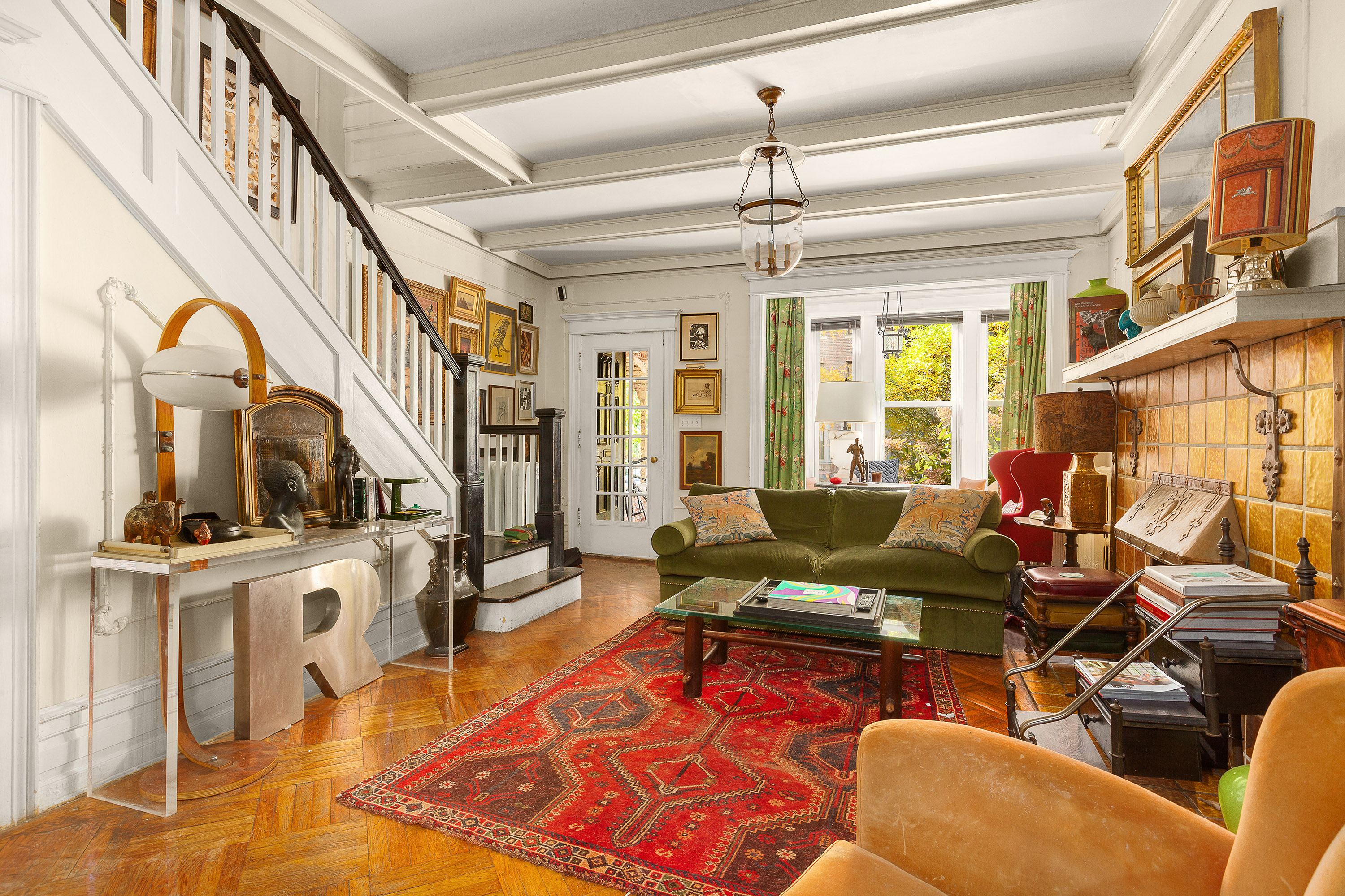 a living room with furniture a fireplace and a chandelier