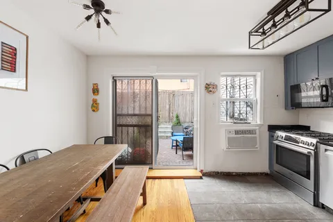 a kitchen with a stove a sink and cabinets