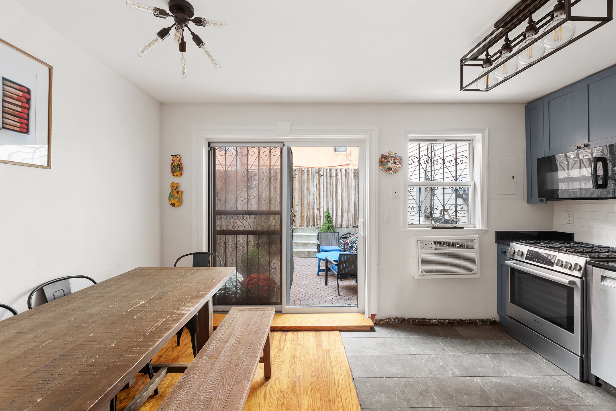 2551 Frederick Douglass Boulevard, Unit B Manhattan, NY 10030 - Photo 4 of 9 a kitchen with a stove a sink and cabinets