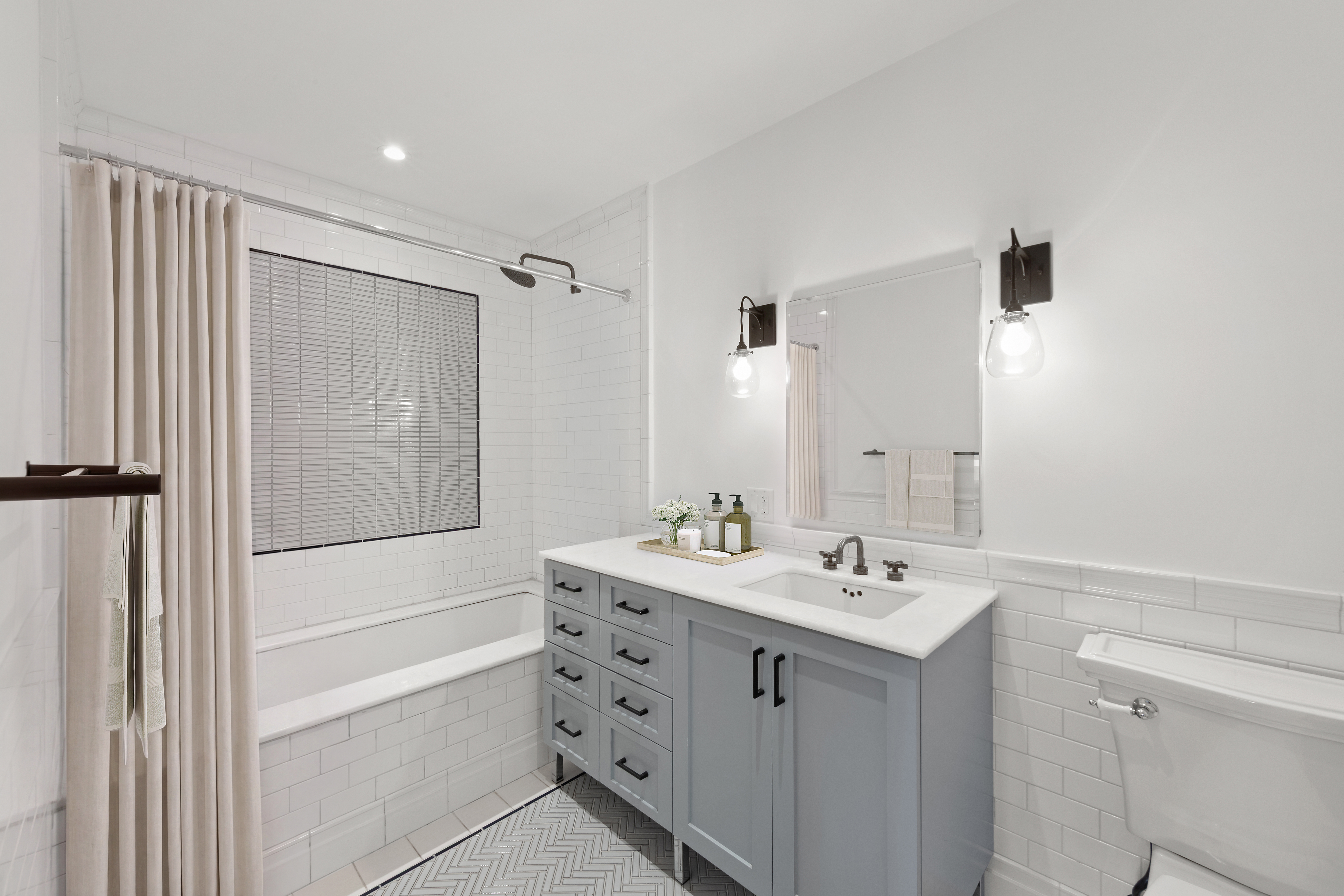 265 State Street, Unit 1008 Brooklyn, NY 11201 - Photo 7 of 19 a bathroom with a double vanity sink a mirror a shower and a bathtub