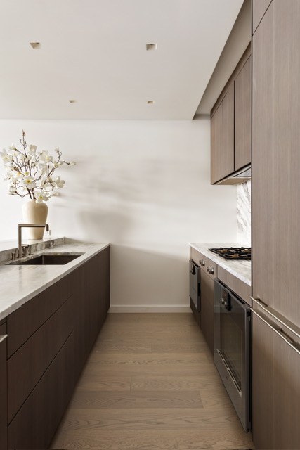 500 West 18th Street, Unit WEST 5E Manhattan, NY 10011 - Photo 4 of 15 a kitchen with a sink cabinets and appliances