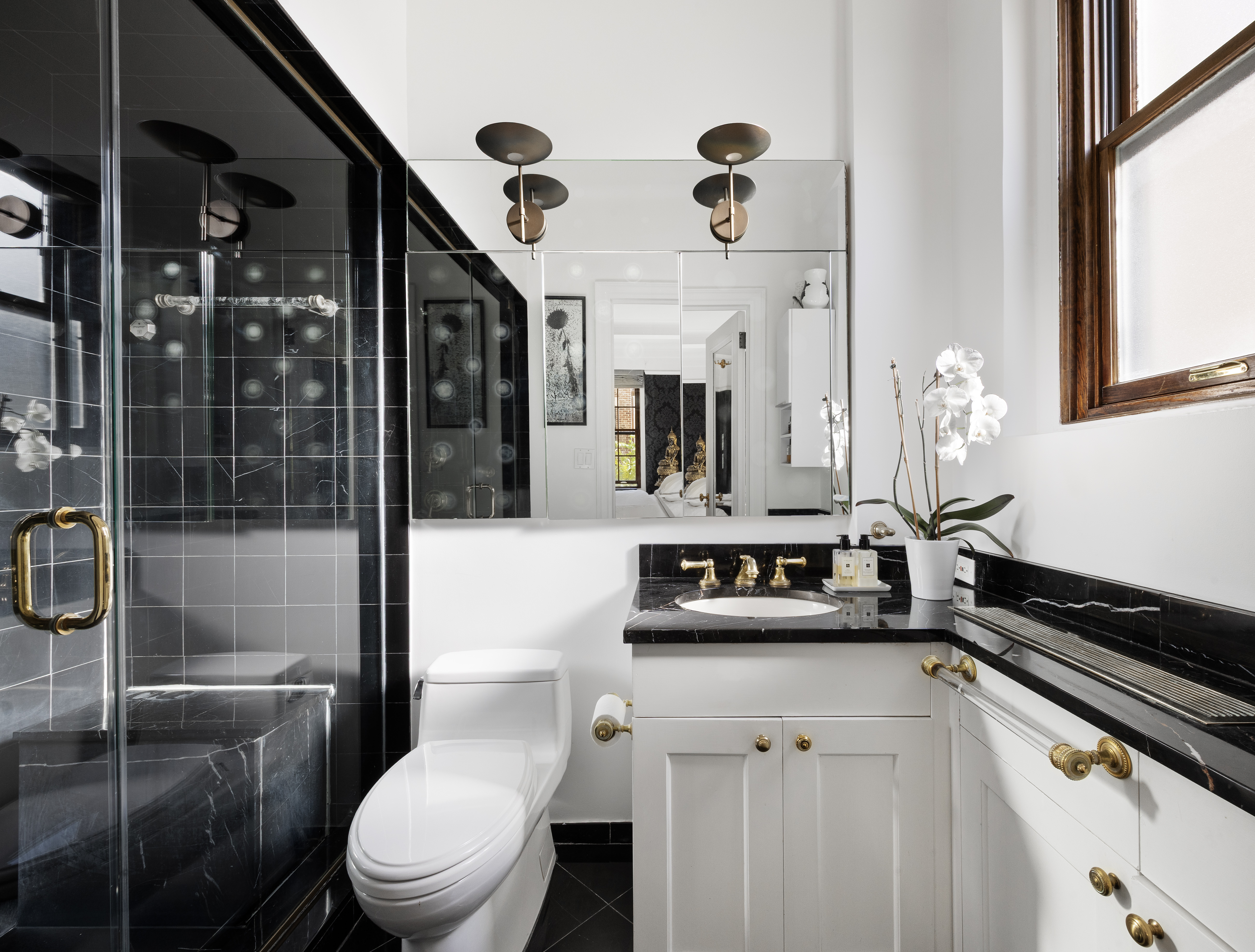 14 East 75th Street, Unit 7E Manhattan, NY 10021 - Photo 10 of 13 a bathroom with a sink a toilet and shower