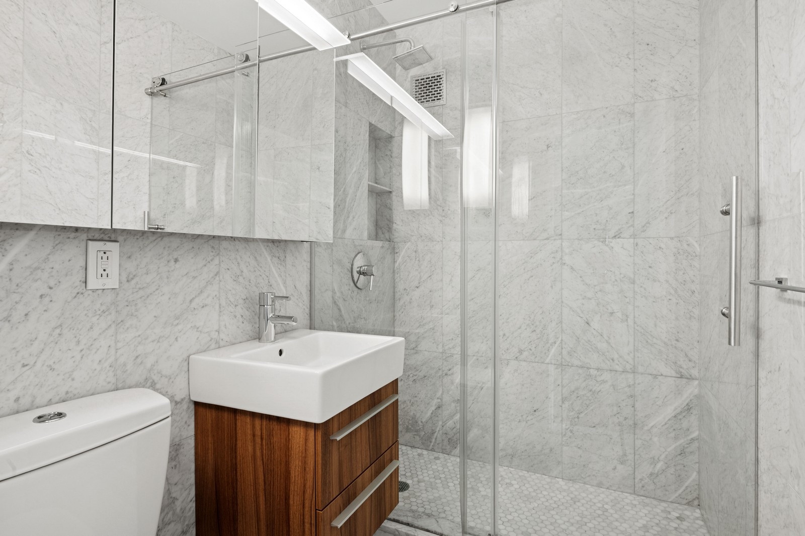 205 3rd Avenue, Unit 21H Manhattan, NY 10003 - Photo 10 of 17 a bathroom with a sink a toilet and shower