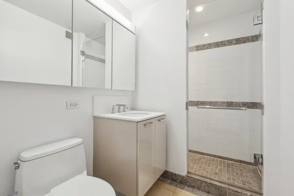 a bathroom with a sink toilet and shower