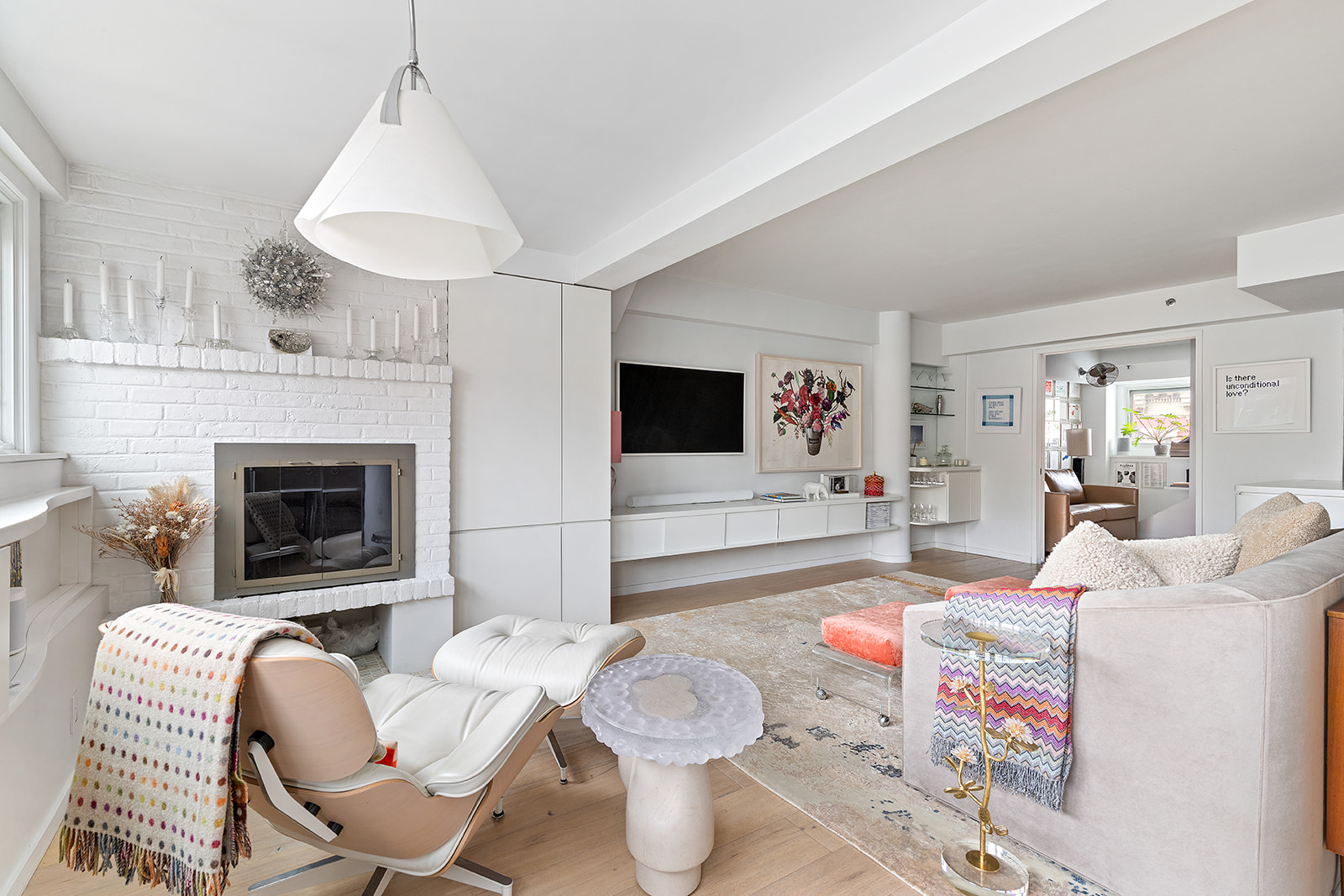 357 West 12th Street, Unit 5E Manhattan, NY 10014 - Photo 3 of 13 a living room with furniture and a fireplace