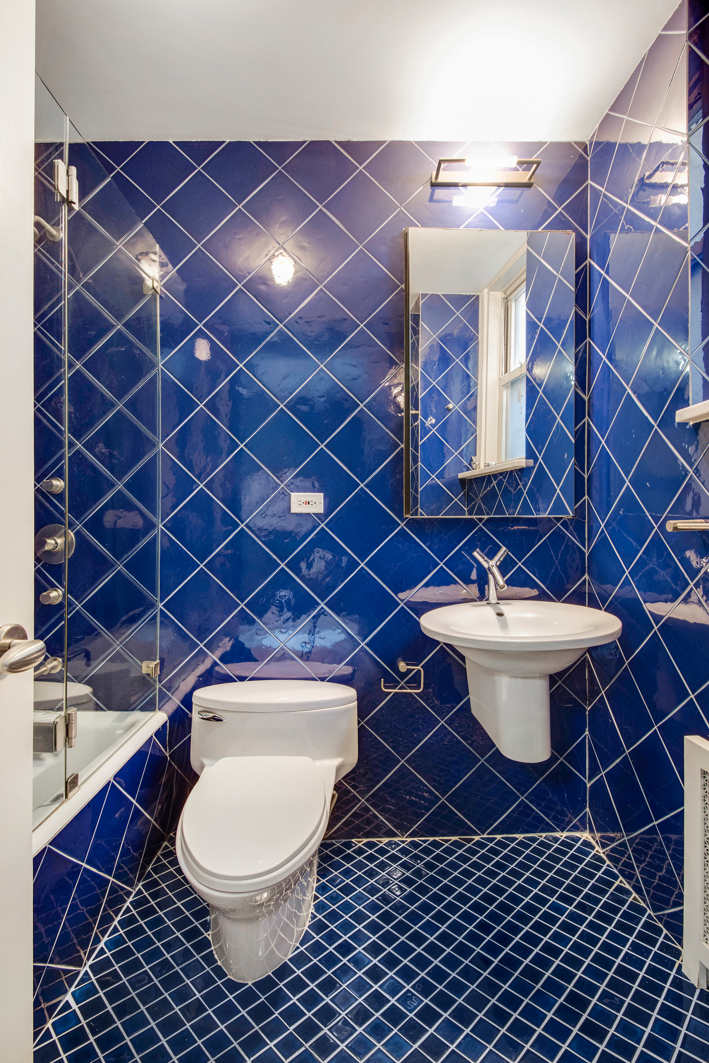 434 East 52nd Street, Unit 1BH Manhattan, NY 10022 - Photo 16 of 23 a bathroom with a toilet and a sink