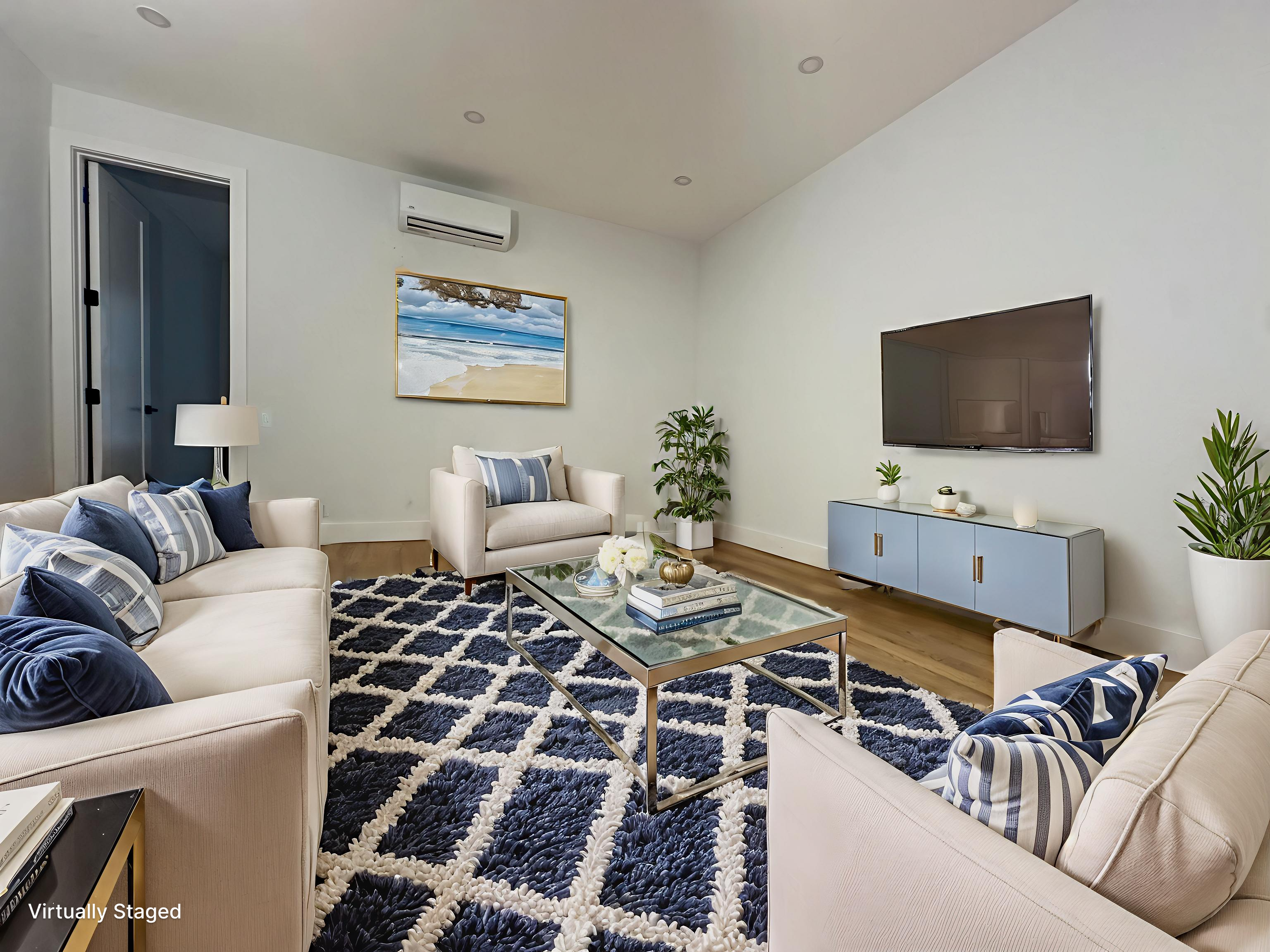 a living room with furniture a rug and a flat screen tv