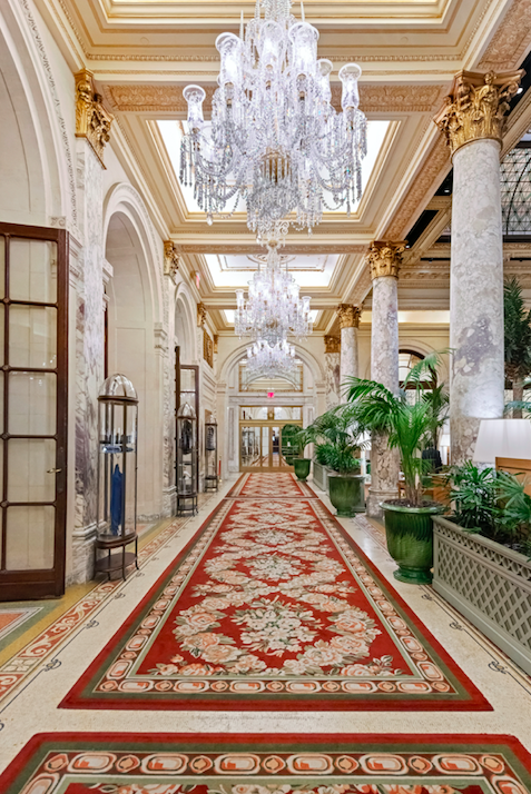 1 Central Park South, Unit 1241 Manhattan, NY 10019 - Photo 8 of 14 a view of a hallway with a chandelier and dining table