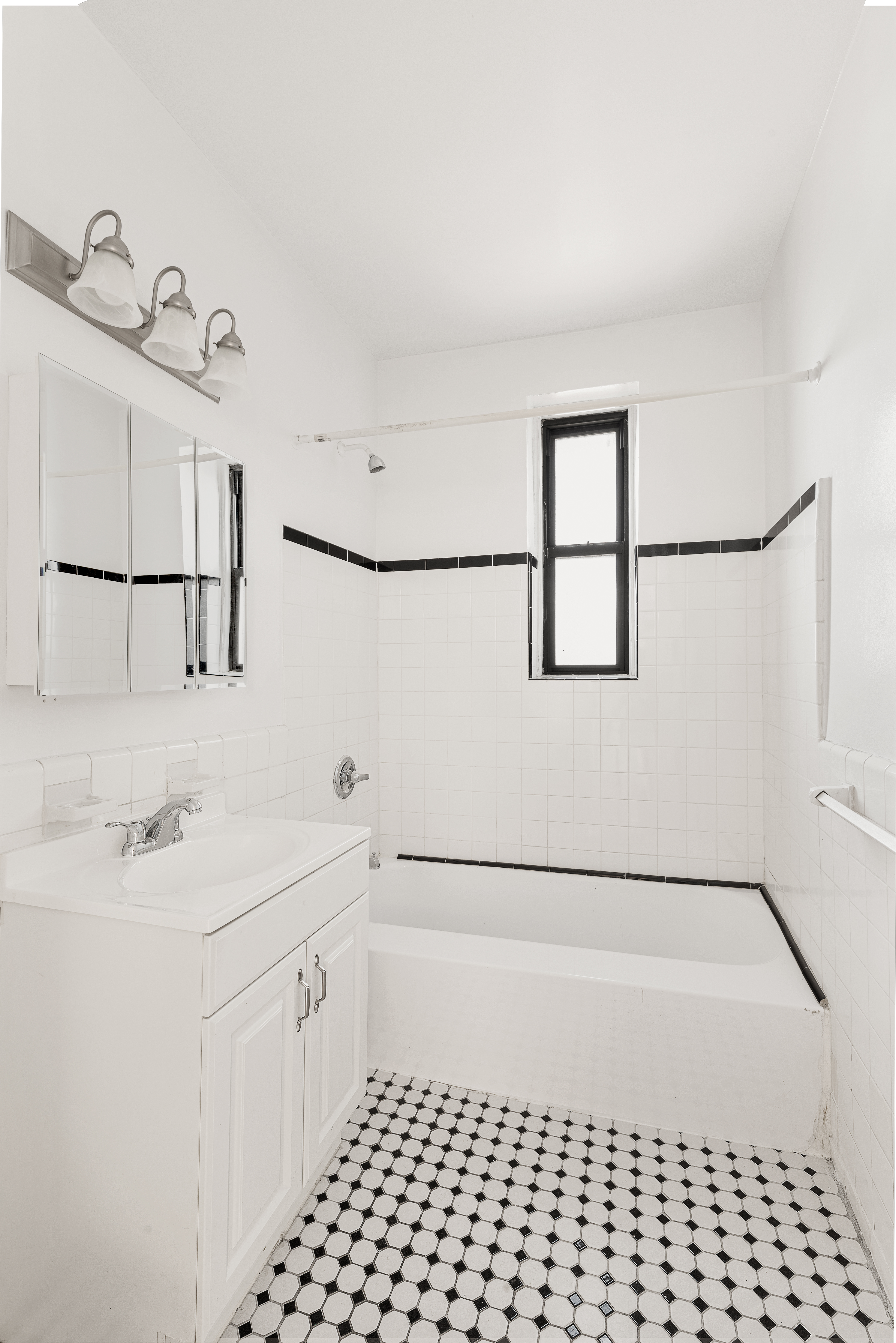 158-18 Riverside Drive West, Unit 4E50 Manhattan, NY 10032 - Photo 9 of 17 a bathroom with a sink a toilet and shower