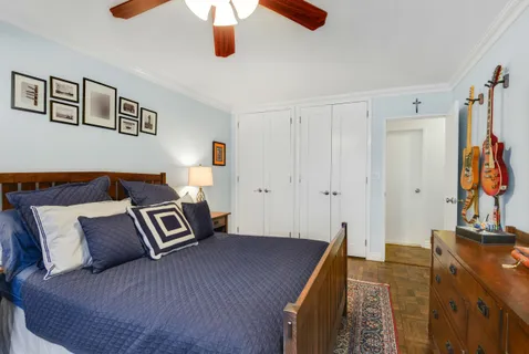 a spacious bedroom with a bed and a flat tv screen