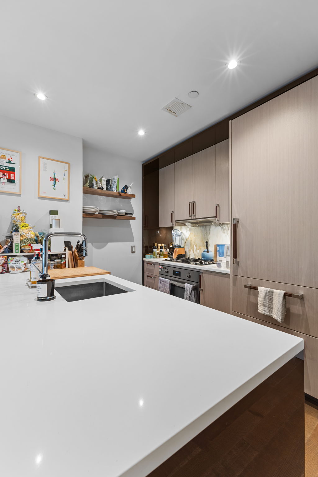 261 West 25th Street, Unit 4A Manhattan, NY 10001 - Photo 4 of 16 a kitchen with sink a refrigerator and cabinets