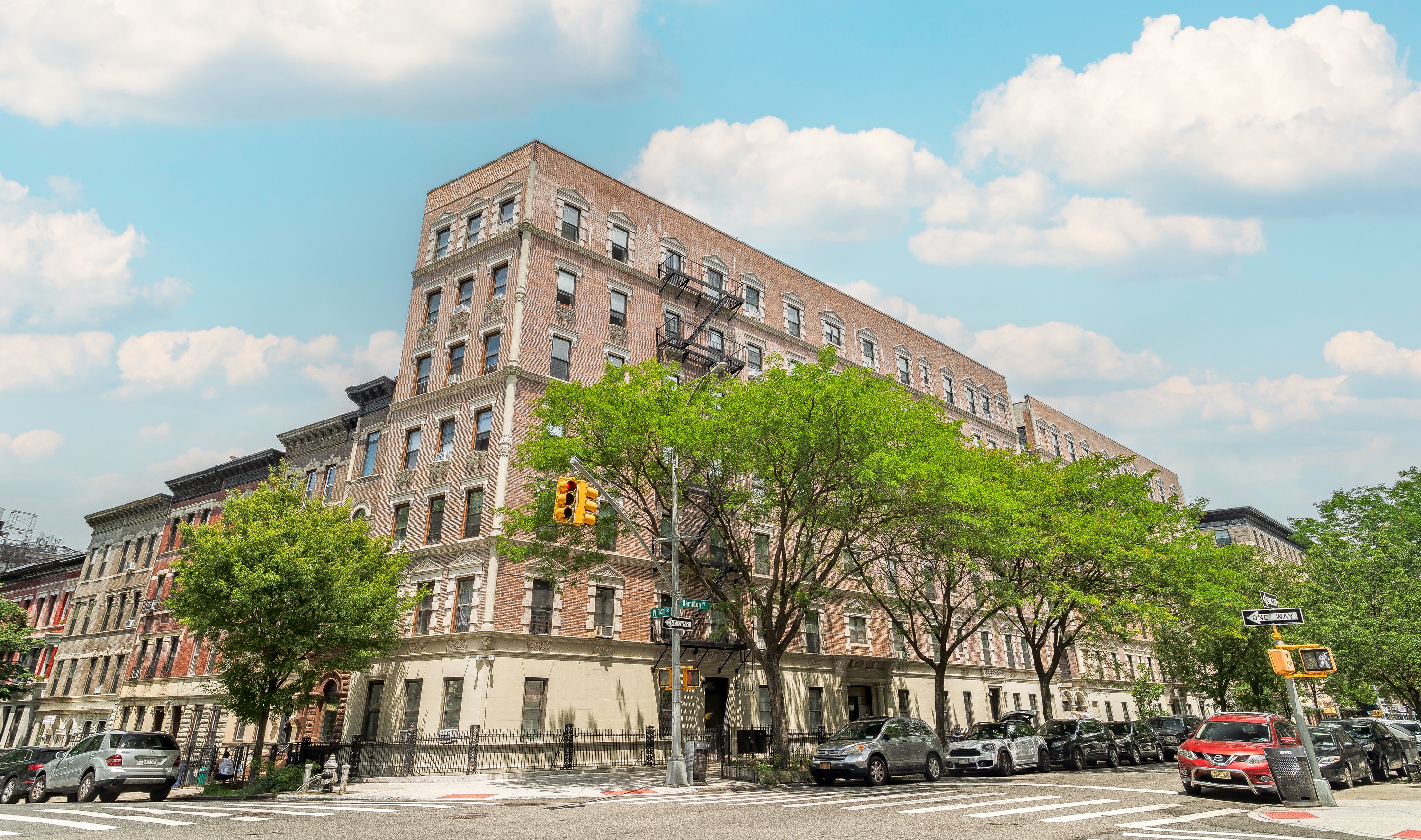 94 Hamilton Place, Unit 6E Manhattan, NY 10031 - Photo 15 of 16 a city street lined with buildings and trees