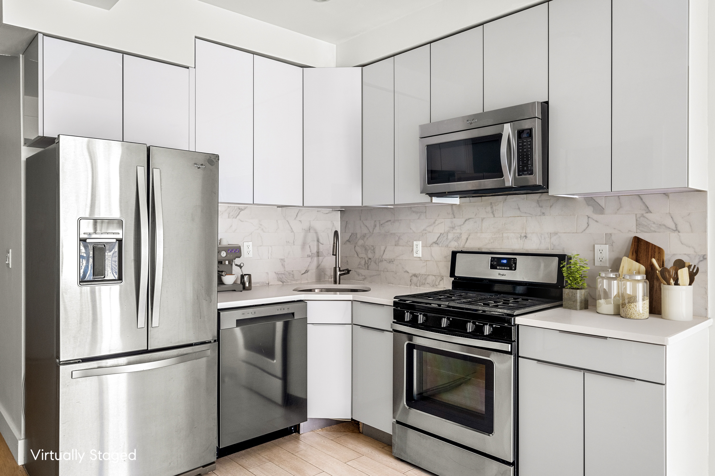 399 East 8th Street, Unit 1A Manhattan, NY 10009 - Photo 2 of 13 a kitchen with stainless steel appliances white cabinets white stove a microwave and a refrigerator