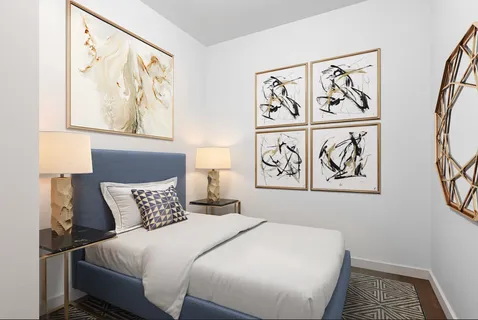 a bedroom with a bed and painting on the wall