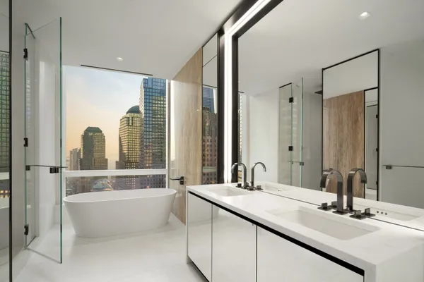 a bathroom with a double vanity sink and a bathtub