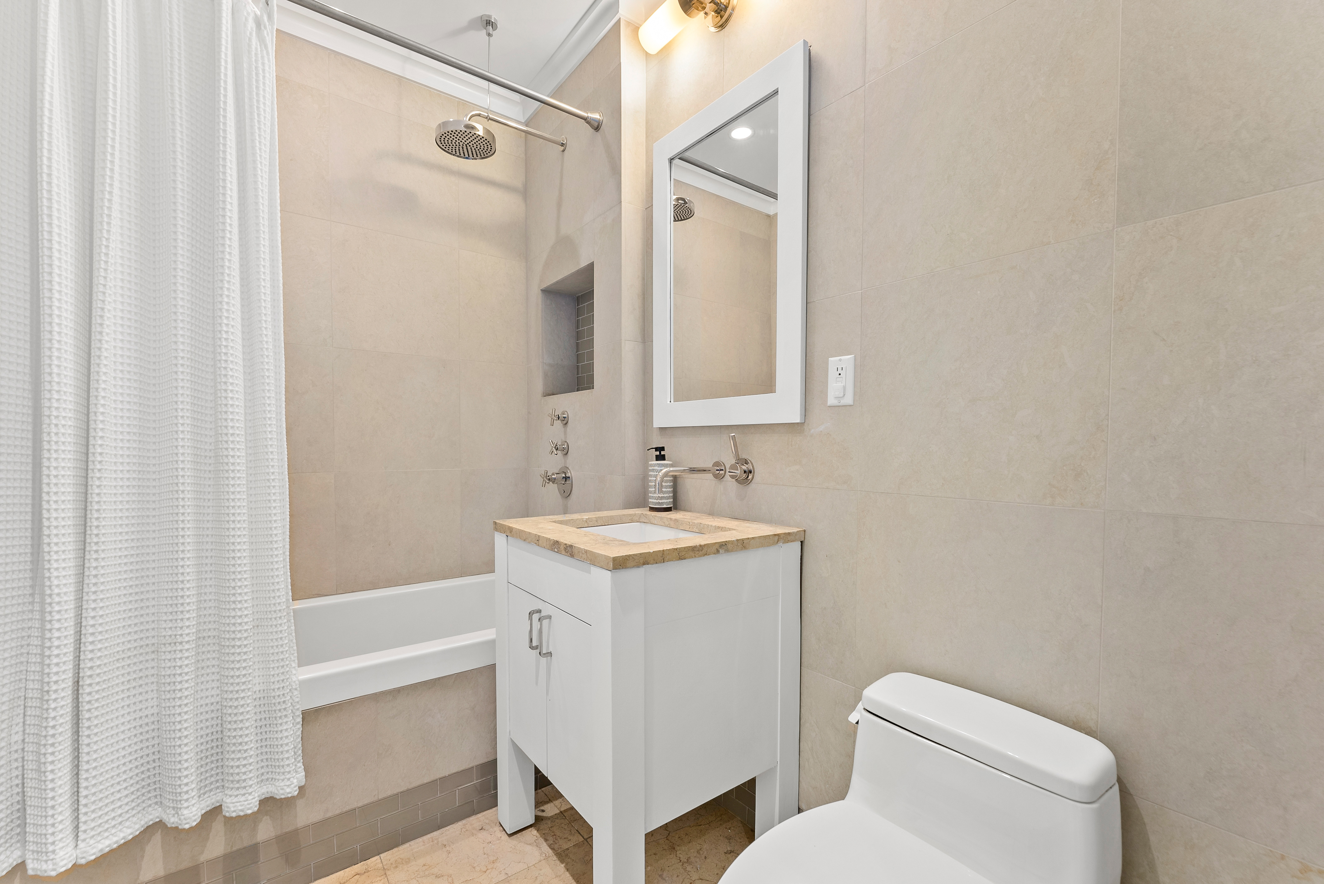 15 West 20th Street, Unit 9A Manhattan, NY 10011 - Photo 13 of 21 a bathroom with a granite countertop sink toilet and shower