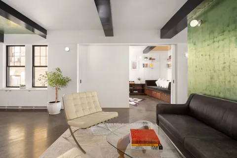 a living room with furniture and wooden floor