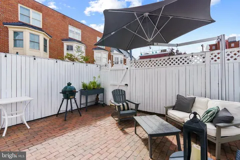 a view of a patio with table and chairs