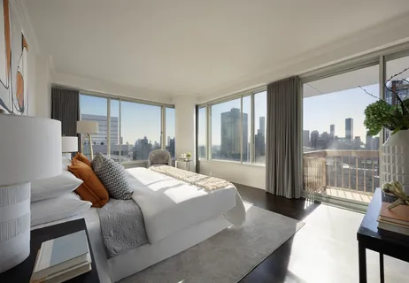 a bedroom with a bed and glass window